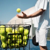 side-view-man-taking-ball-from-container (1)